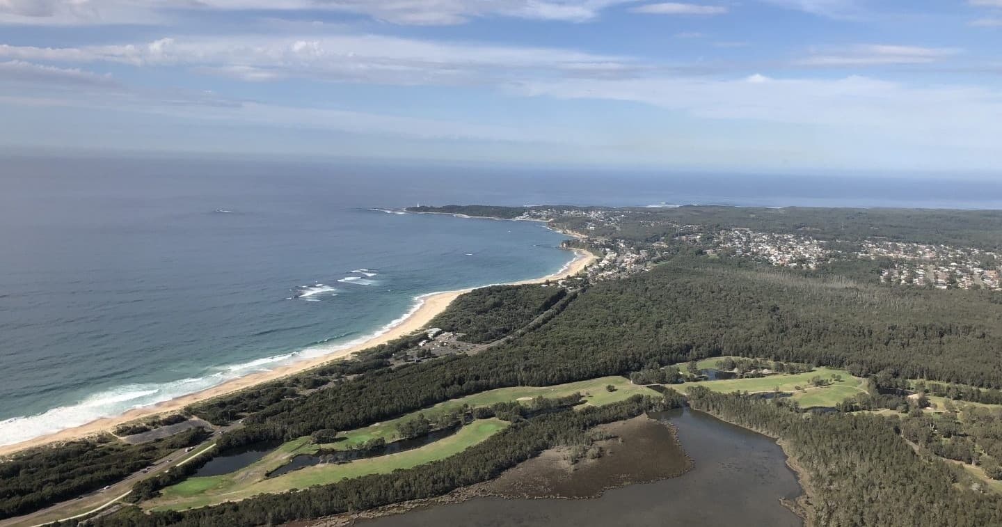 Coastal aerial view of beachhead and rolling dune coastline