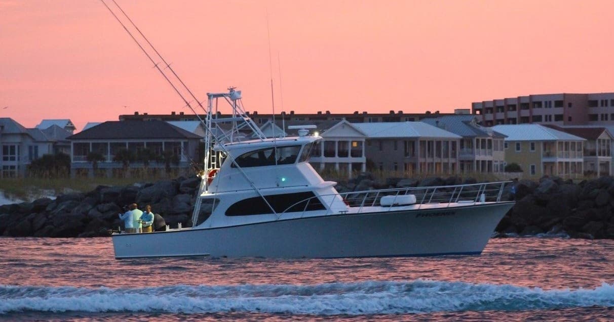Charter boat at sunset near coastal harbor for evening fishing