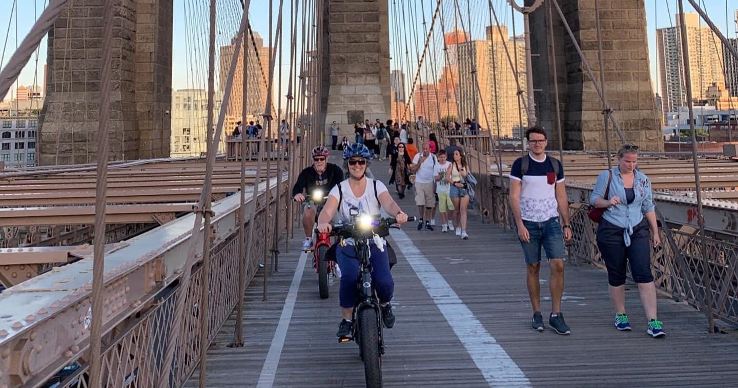 Cyclists crossing Brooklyn Bridge during guided NYC bike tour