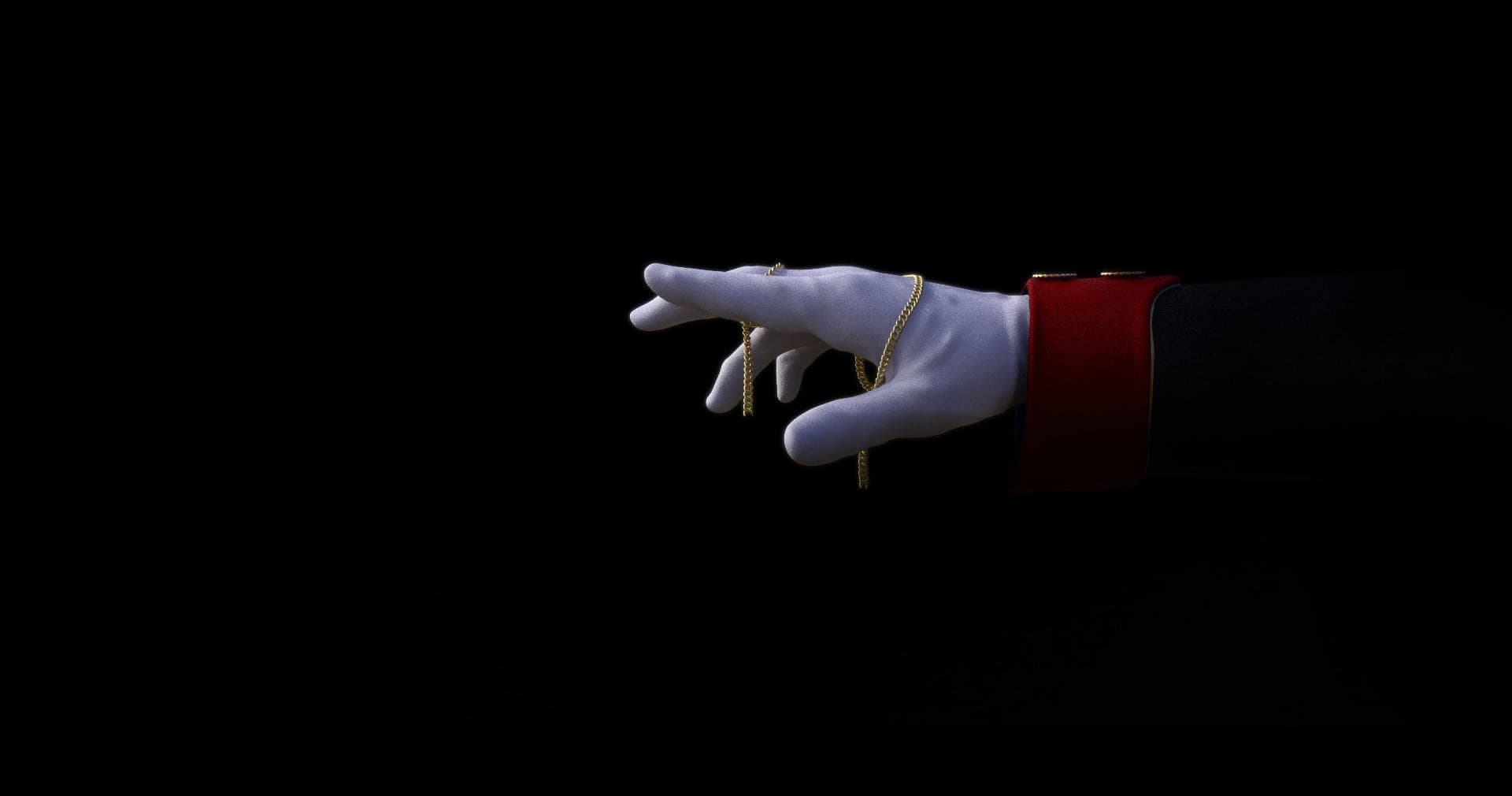 Gloved hand reaching into dark void, theatrical escape room clue