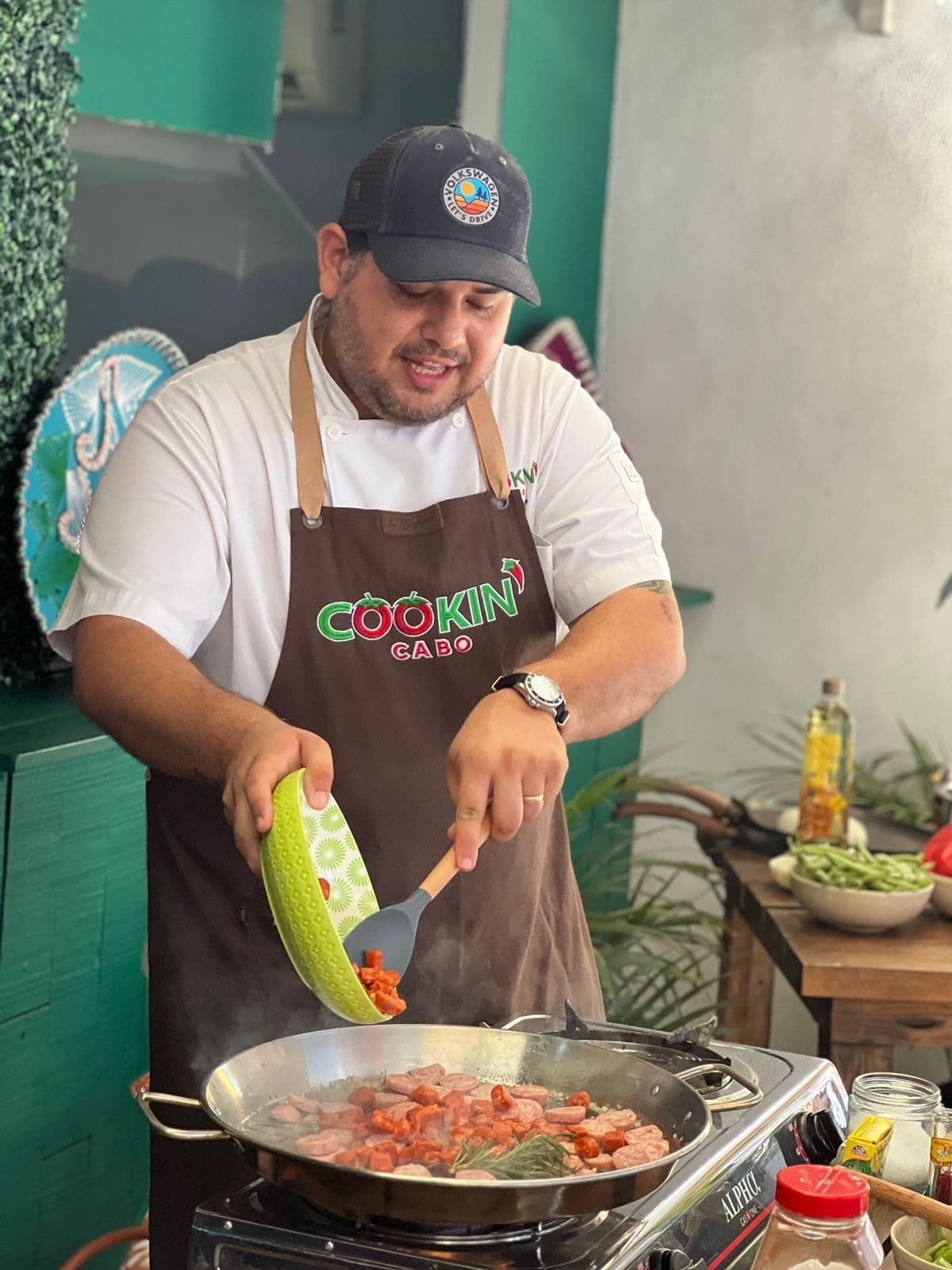 Local chef cooking seafood in open-air stall during food tour