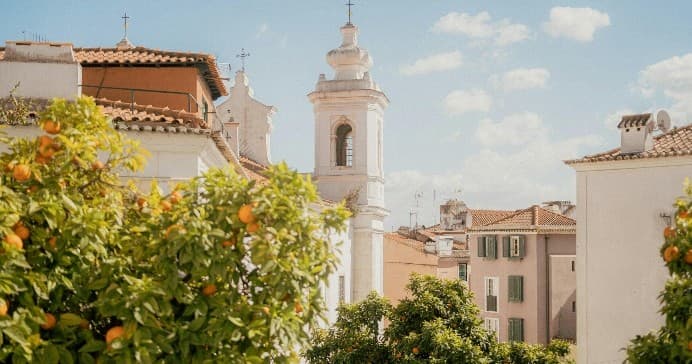 Lisbon orange trees and church tower in Alfama, cultural walking tour