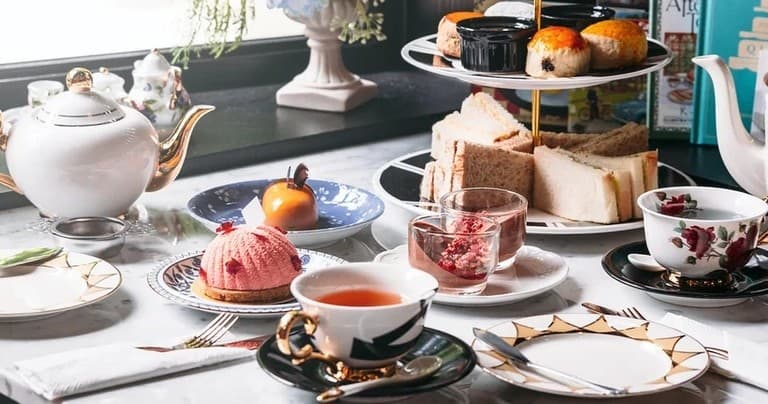 Elegant afternoon tea service with pastries on a decorated table