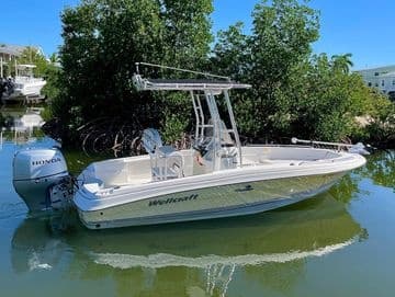 Center-console fishing boat cruising calm mangrove channel