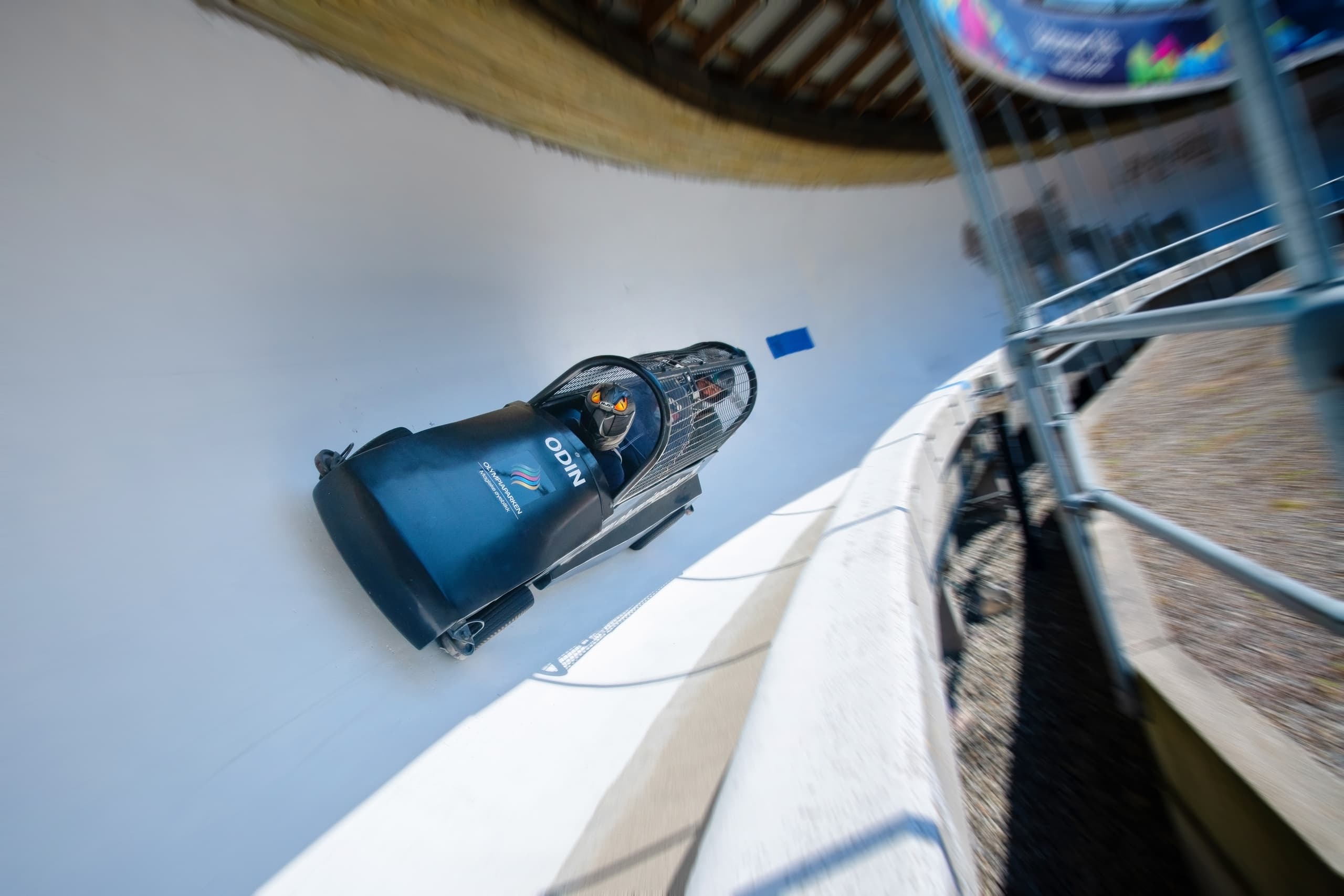 Bobsled speeding on banked ice track at Lillehammer Olympic Park