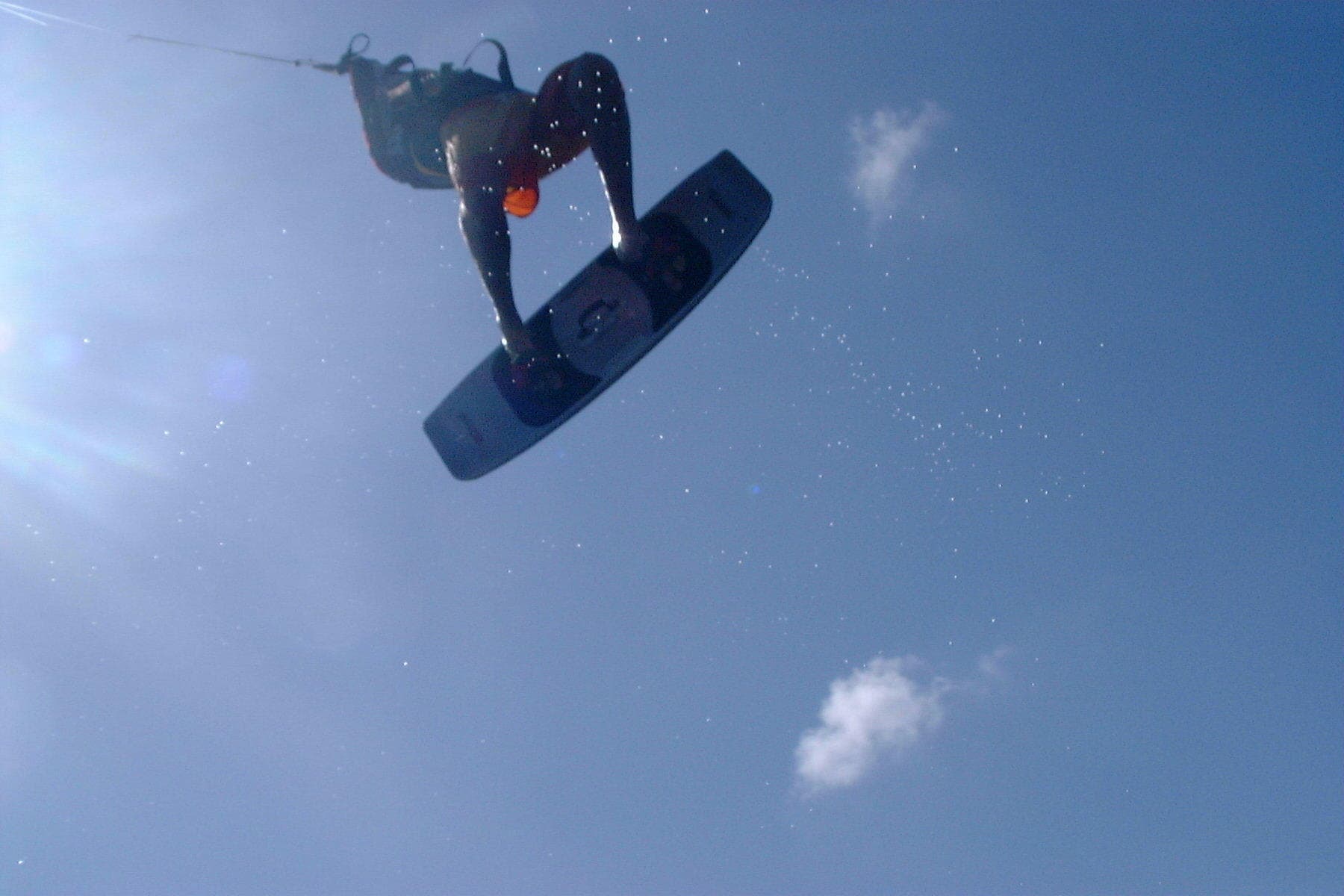 Kitesurfer jumping high over turquoise ocean at Cabarete beach