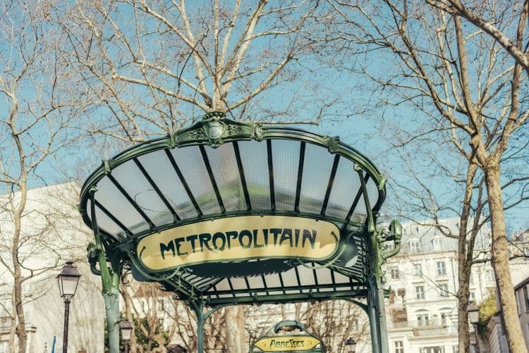 Art Nouveau Métropolitain metro entrance under bare trees in Paris
