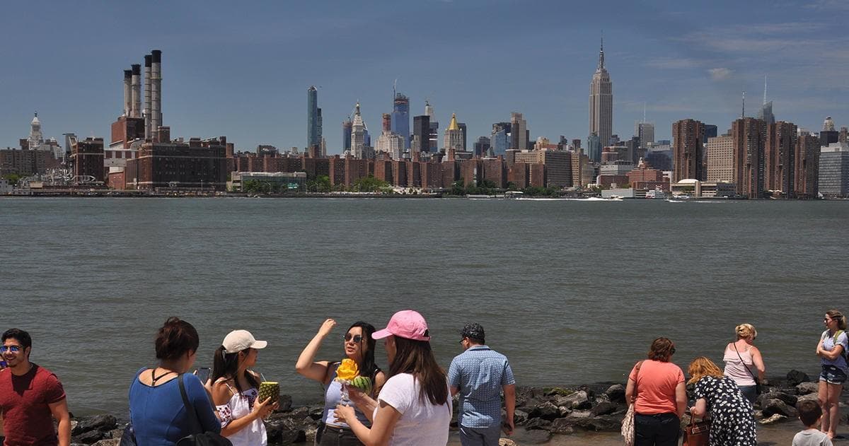 People enjoying Manhattan skyline from Hudson River waterfront