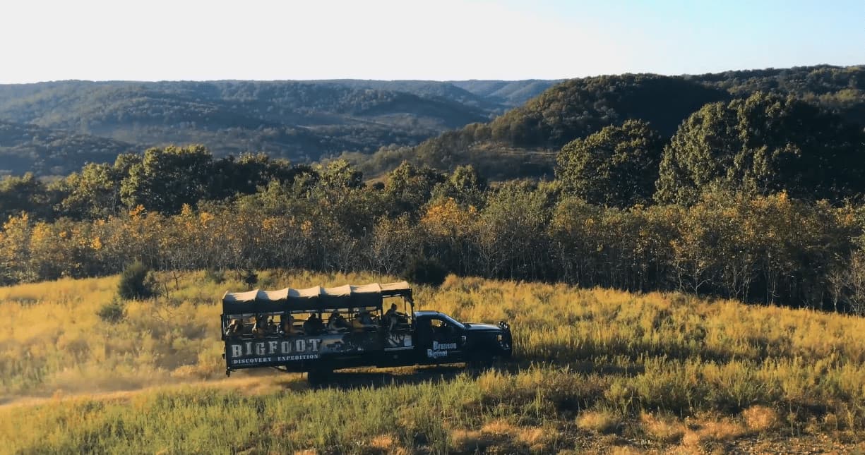 Open-air safari truck touring scenic Ozark hills near Branson