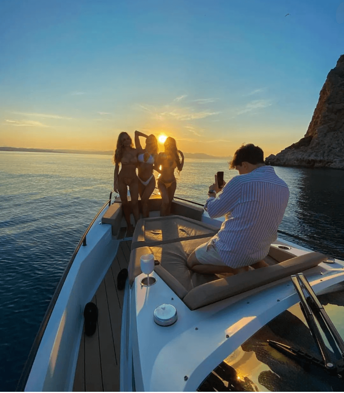 Motorboat anchored in shallow bay with clear Mediterranean water