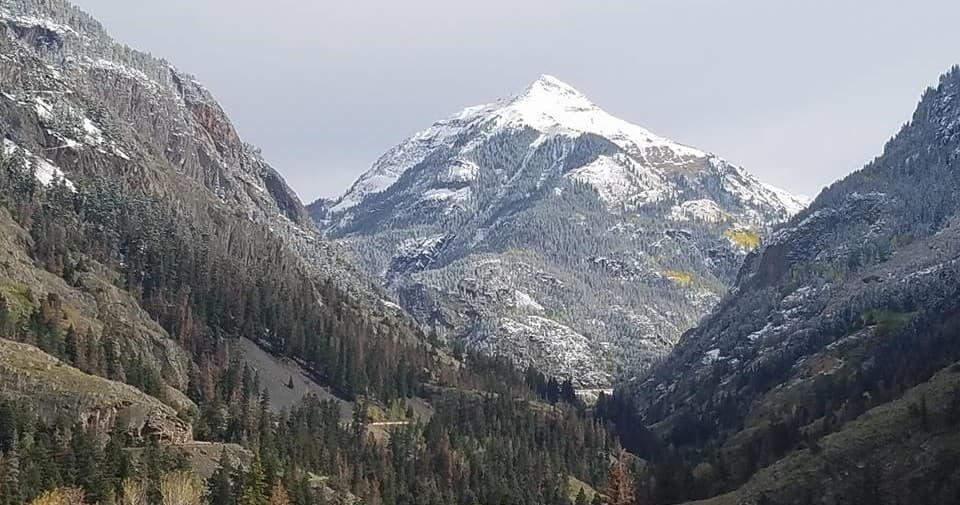 Snow-dusted Colorado mountain valley for scenic hiking tours