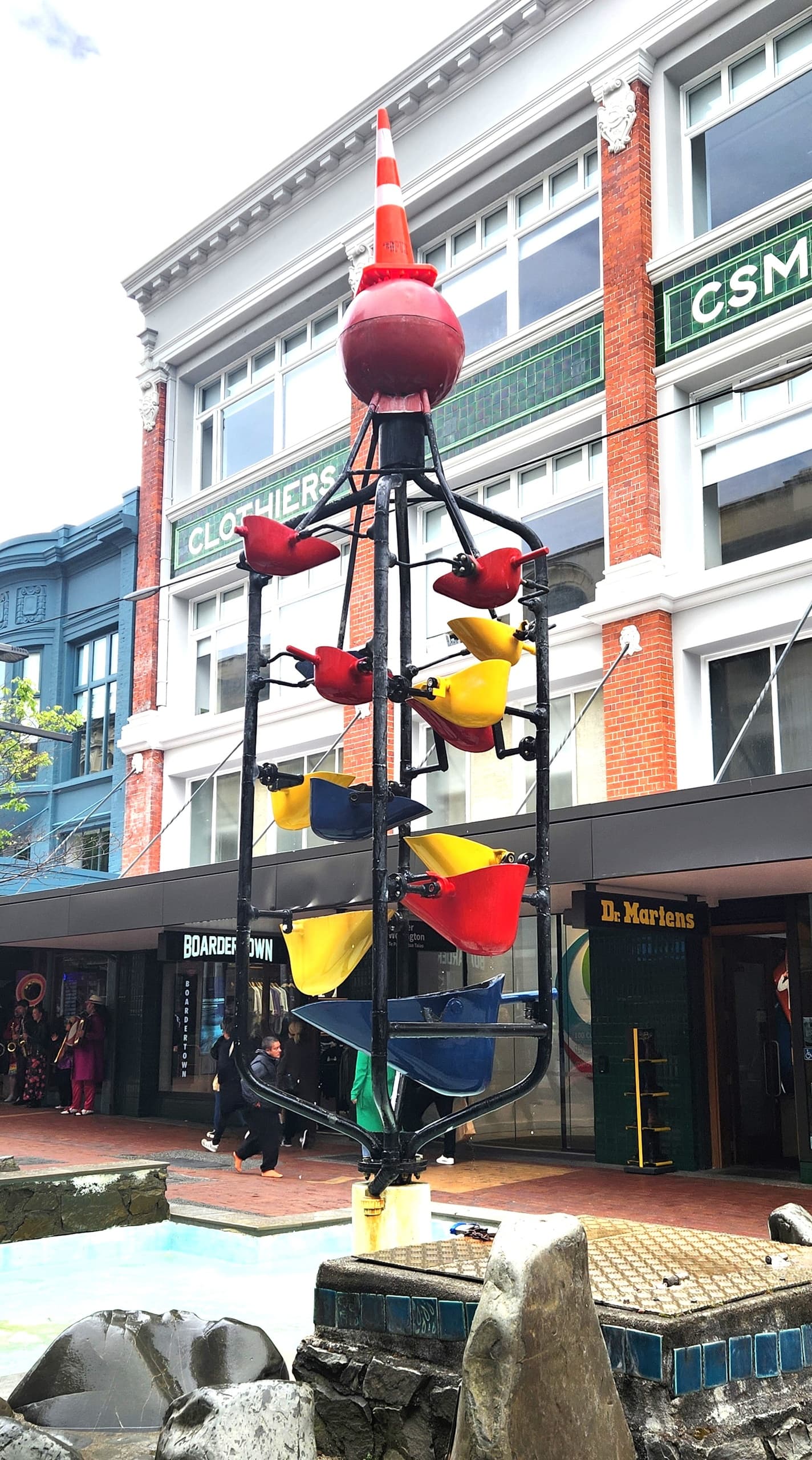 Colorful outdoor sculpture fountain on urban pedestrian street
