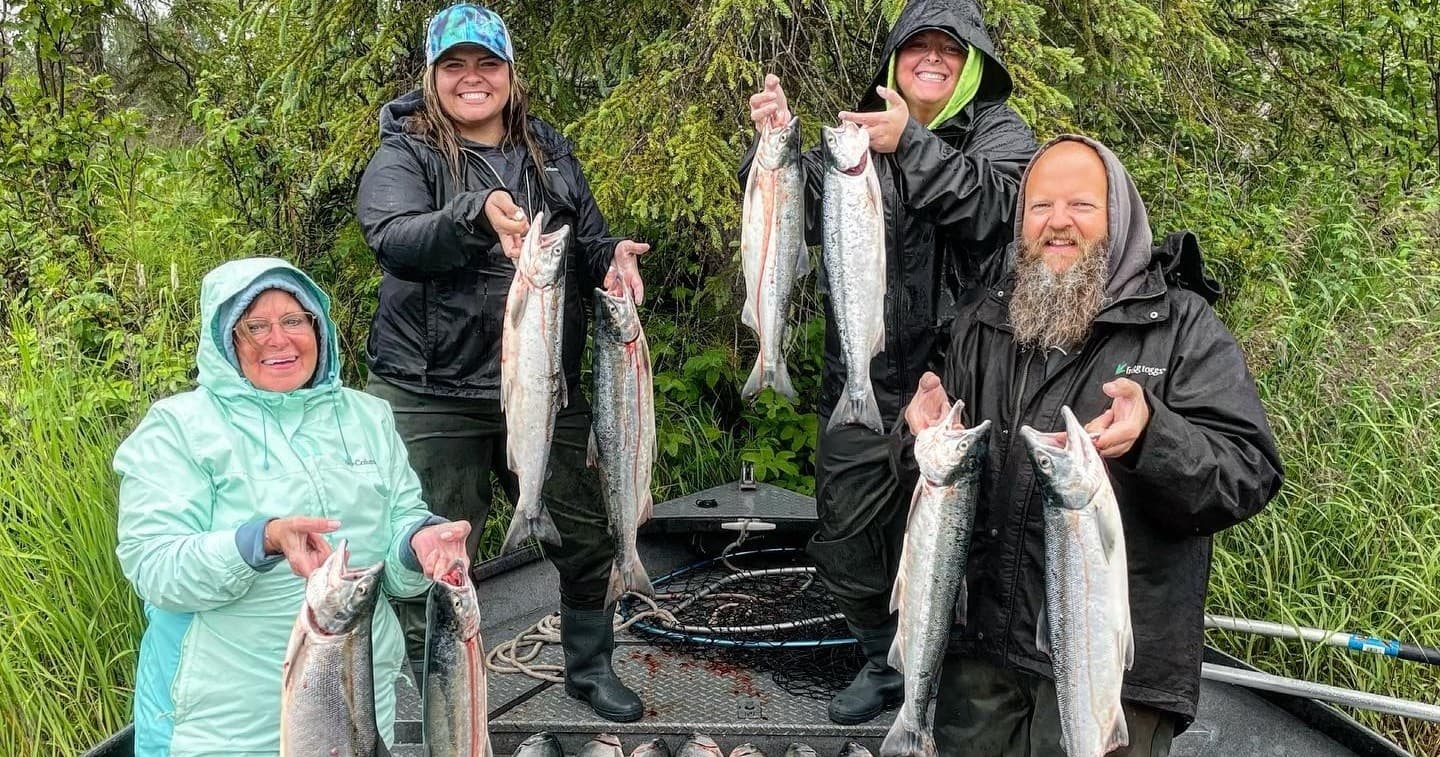 Group of anglers displaying multiple salmon after Alaska guided fishing trip