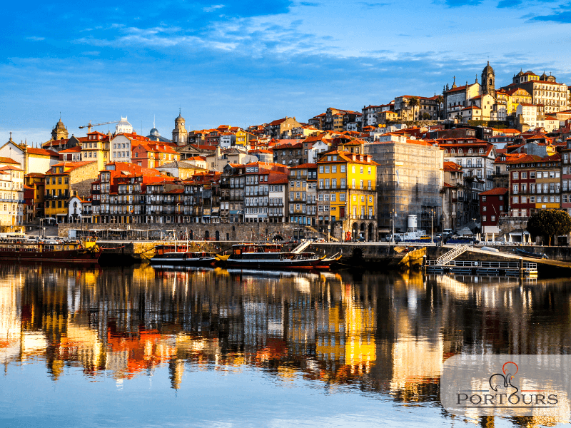 Riverside Porto skyline reflecting on Douro River at sunrise