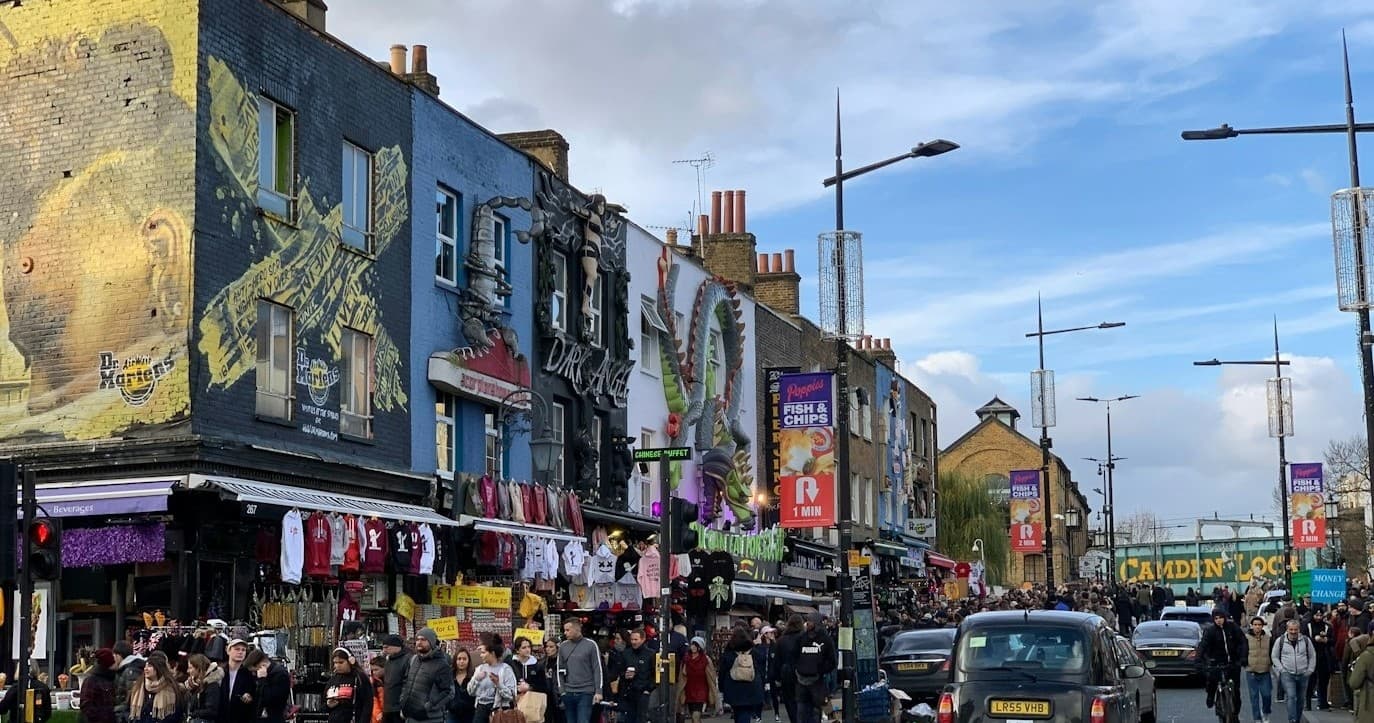 Camden Market street scene with shops, murals, and bustling crowds