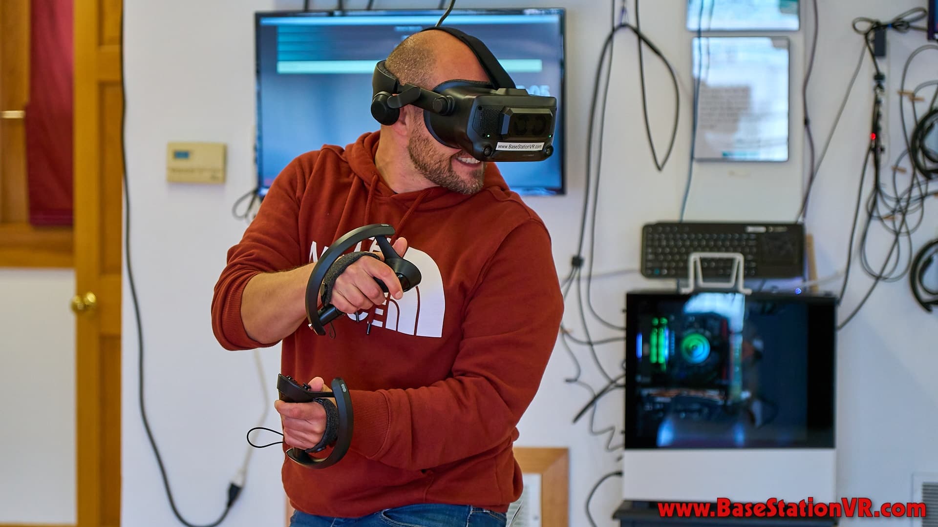 Adult playing immersive VR with controllers in game studio