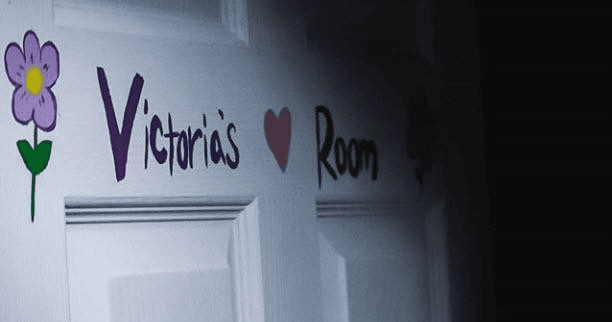 Decorated bedroom door in dim hallway, indoor themed escape clue