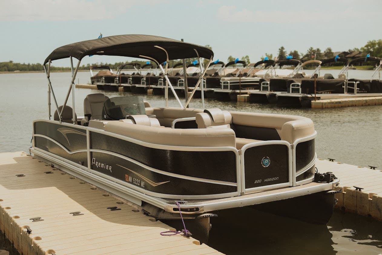 Lakeside pontoon lineup at resort marina beside calm water