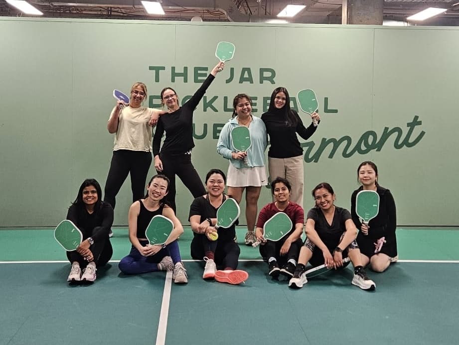 Group of pickleball players holding paddles on indoor court Pyrmont