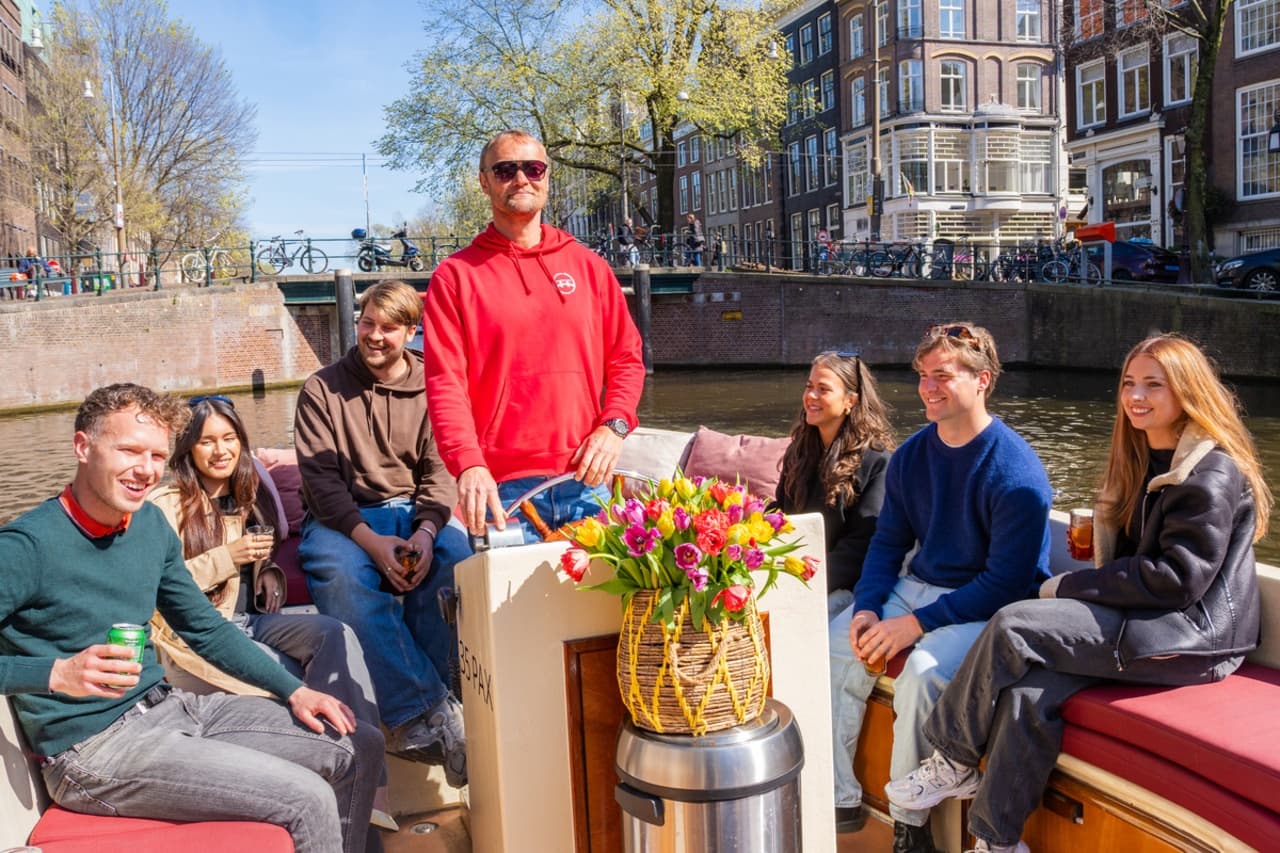 Group social canal boat tour in Amsterdam enjoying city views