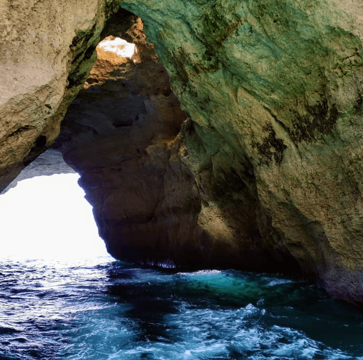 Scenic boat entrance to ocean cave with turquoise surf