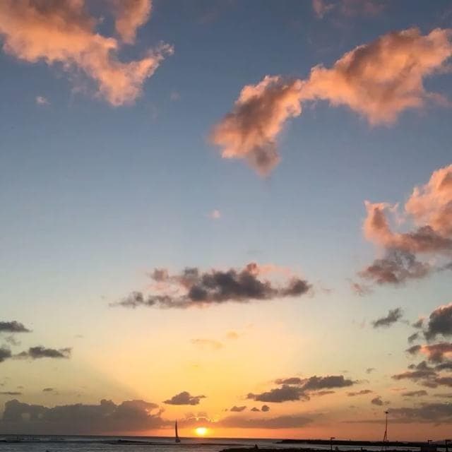 Dramatic tropical sunset with colorful clouds over ocean