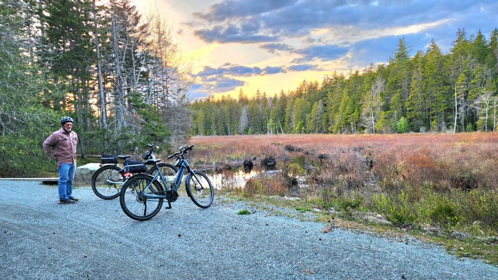 E-bikes and rider stopping on forest trail at golden hour