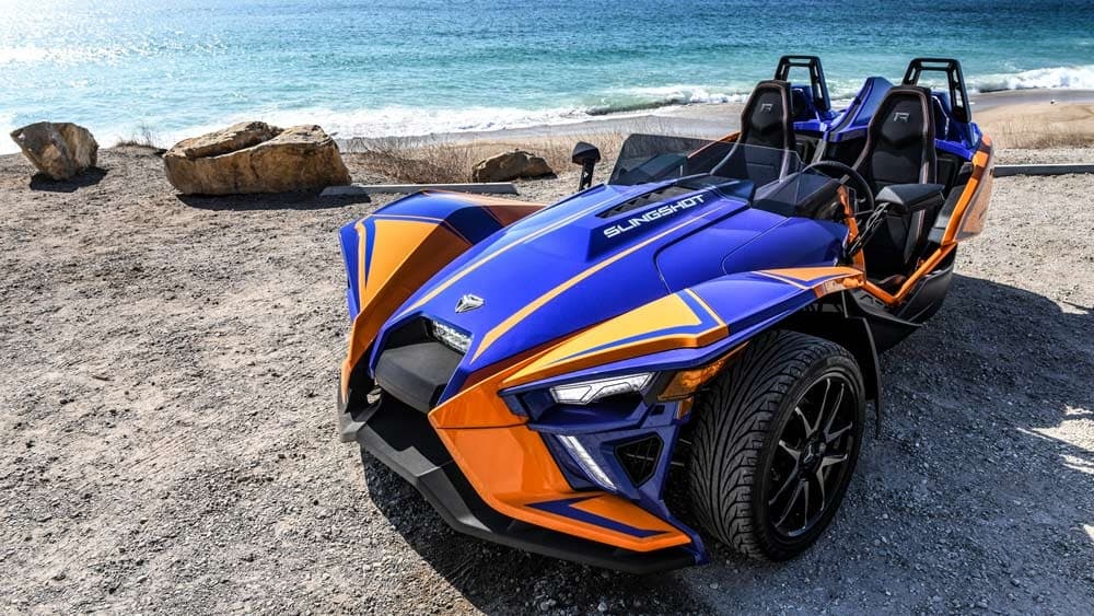 Bright slingshot on rocky beach for scenic seaside driving excursions