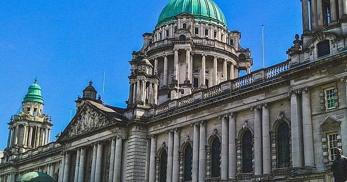 Architectural walking tour: historic city hall facade under blue sky