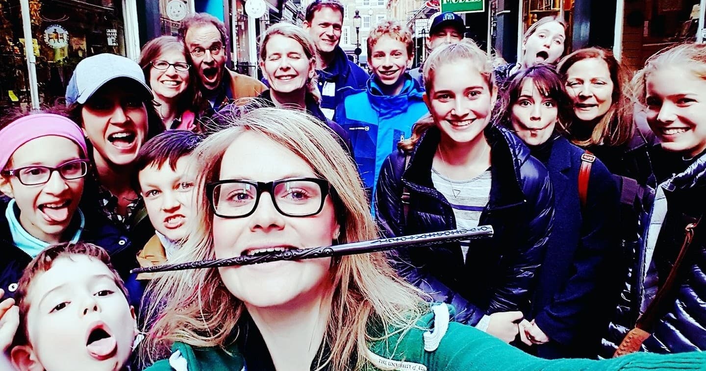 Group selfie of walking tour guests in busy city street