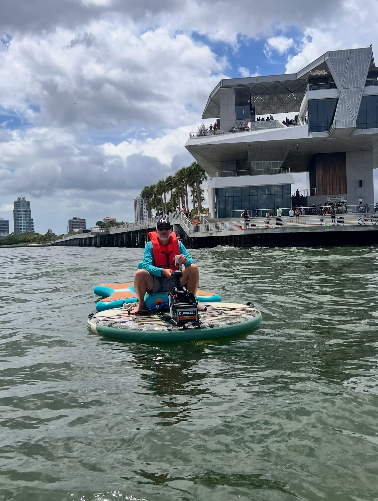 Solo rider on motorized round board by waterfront architecture