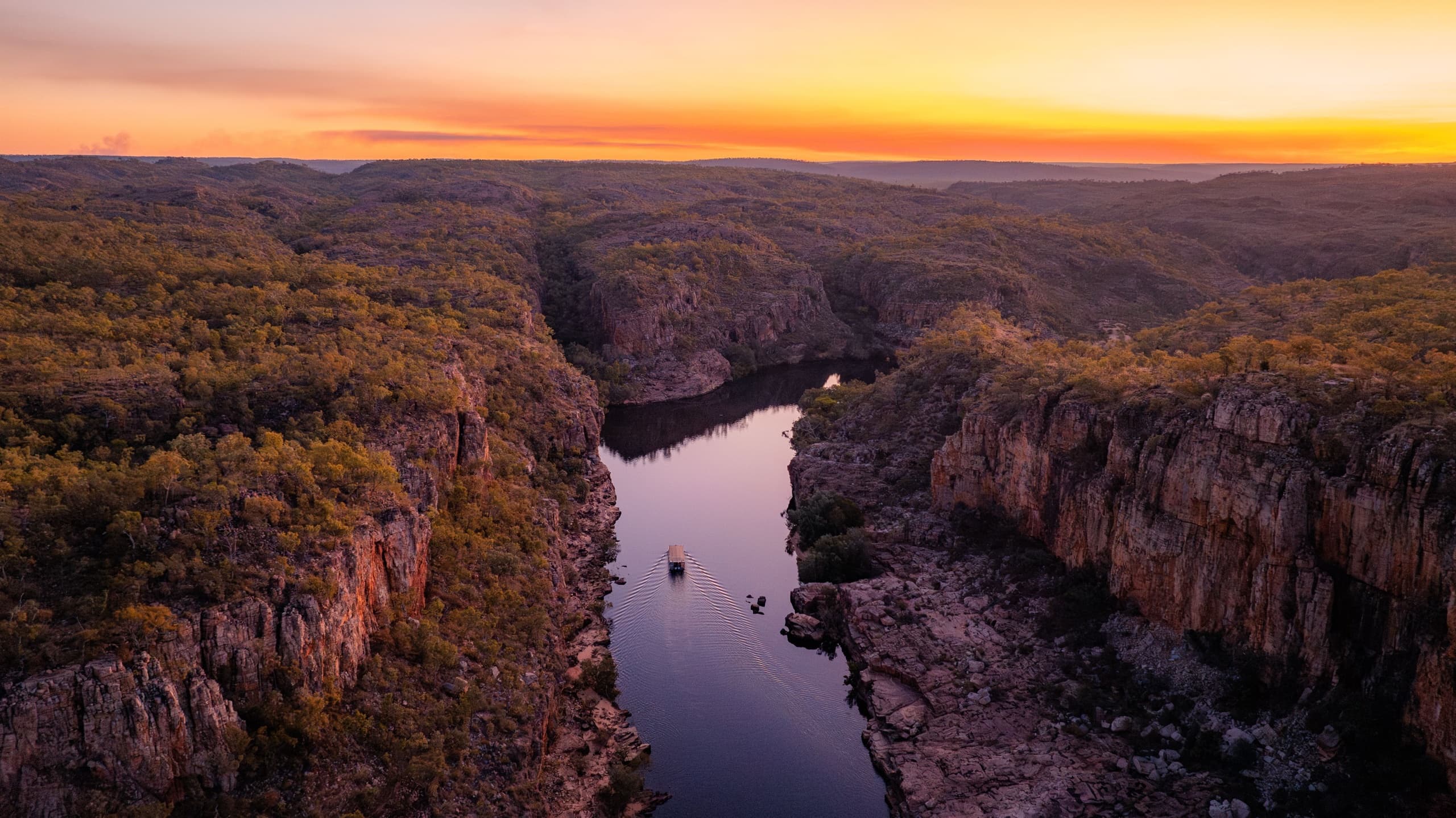 Aerial river gorge at sunset showcasing canyon boating tour