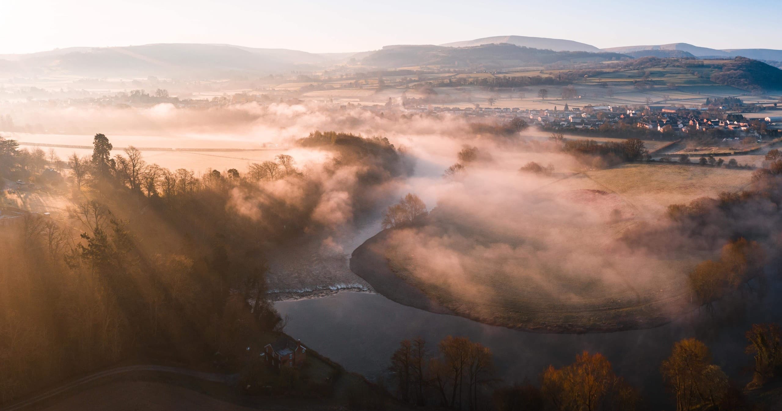 Misty river valley at sunrise, scenic river canoeing landscape