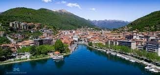Panoramic lake view of Orta town with mountains backdrop