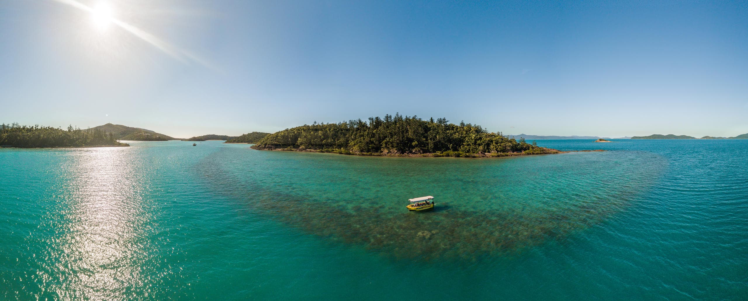 Aerial panorama of tropical island and turquoise bay, scenic view