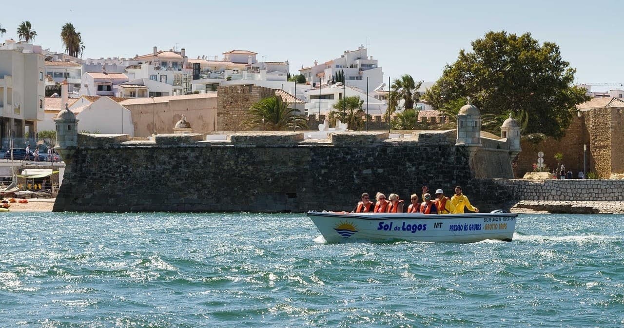 Passengers enjoying coastal sightseeing boat near sea caves