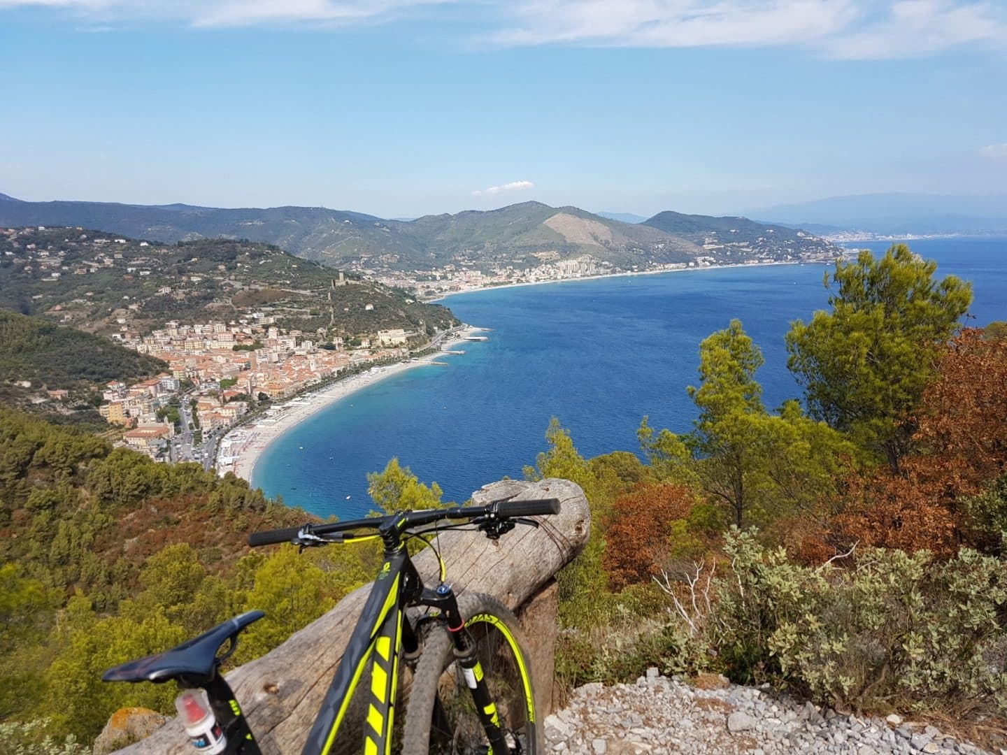 Mountain bike parked overlooking blue bay and seaside vista