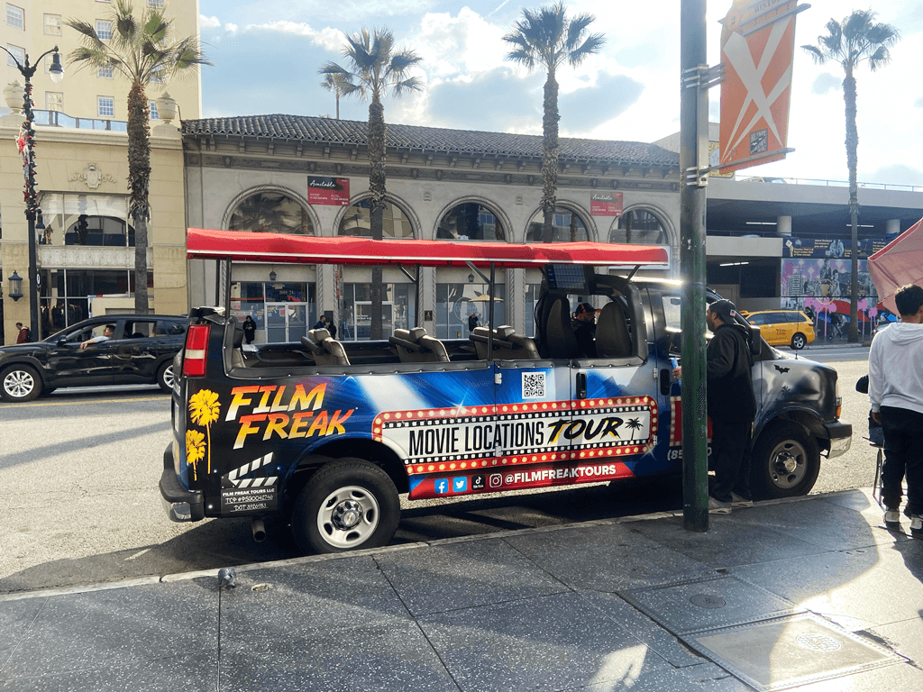 Movie locations tour shuttle parked on Hollywood street, sightseeing