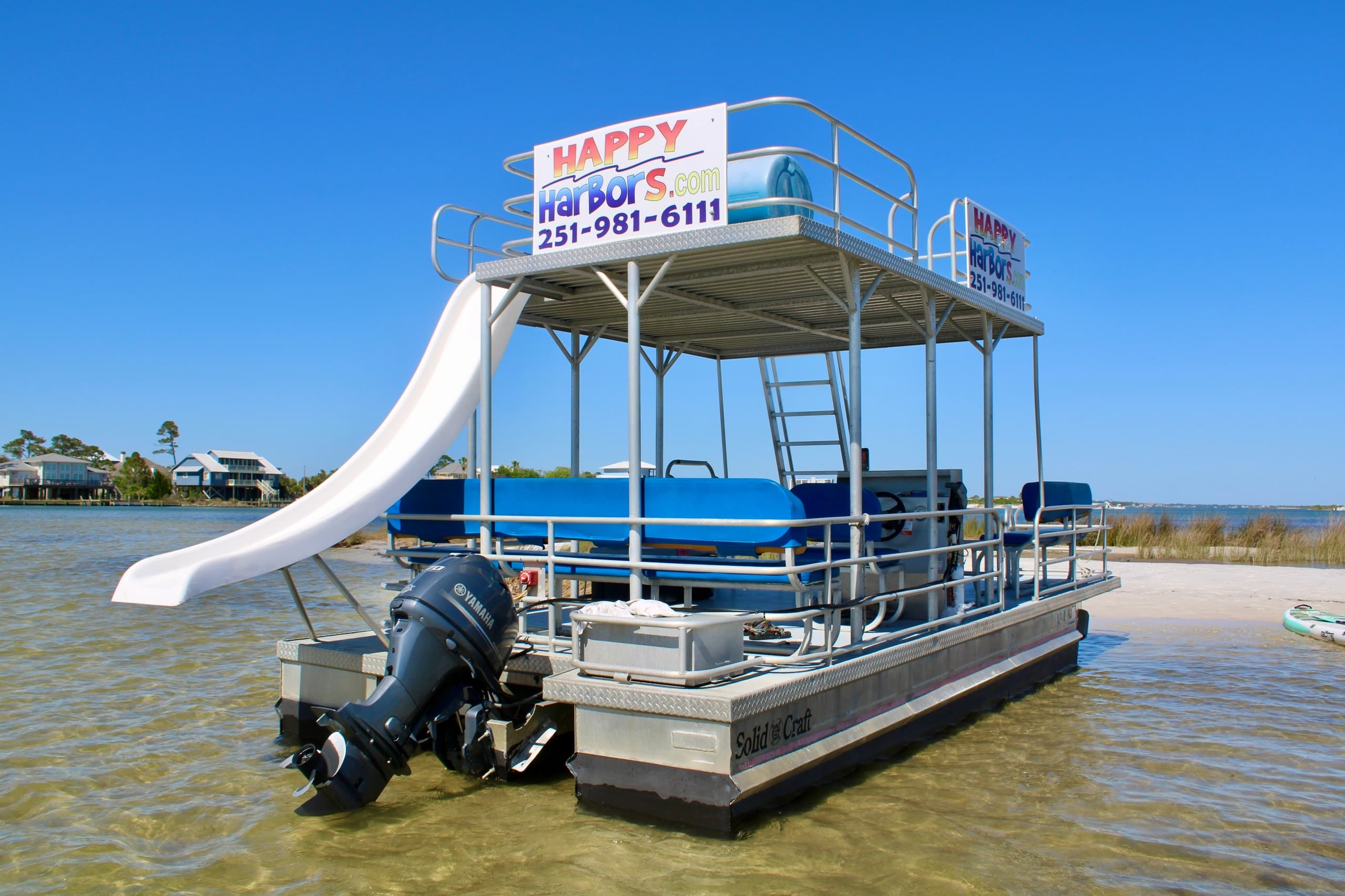 Double-decker pontoon with slide moored in shallow bay