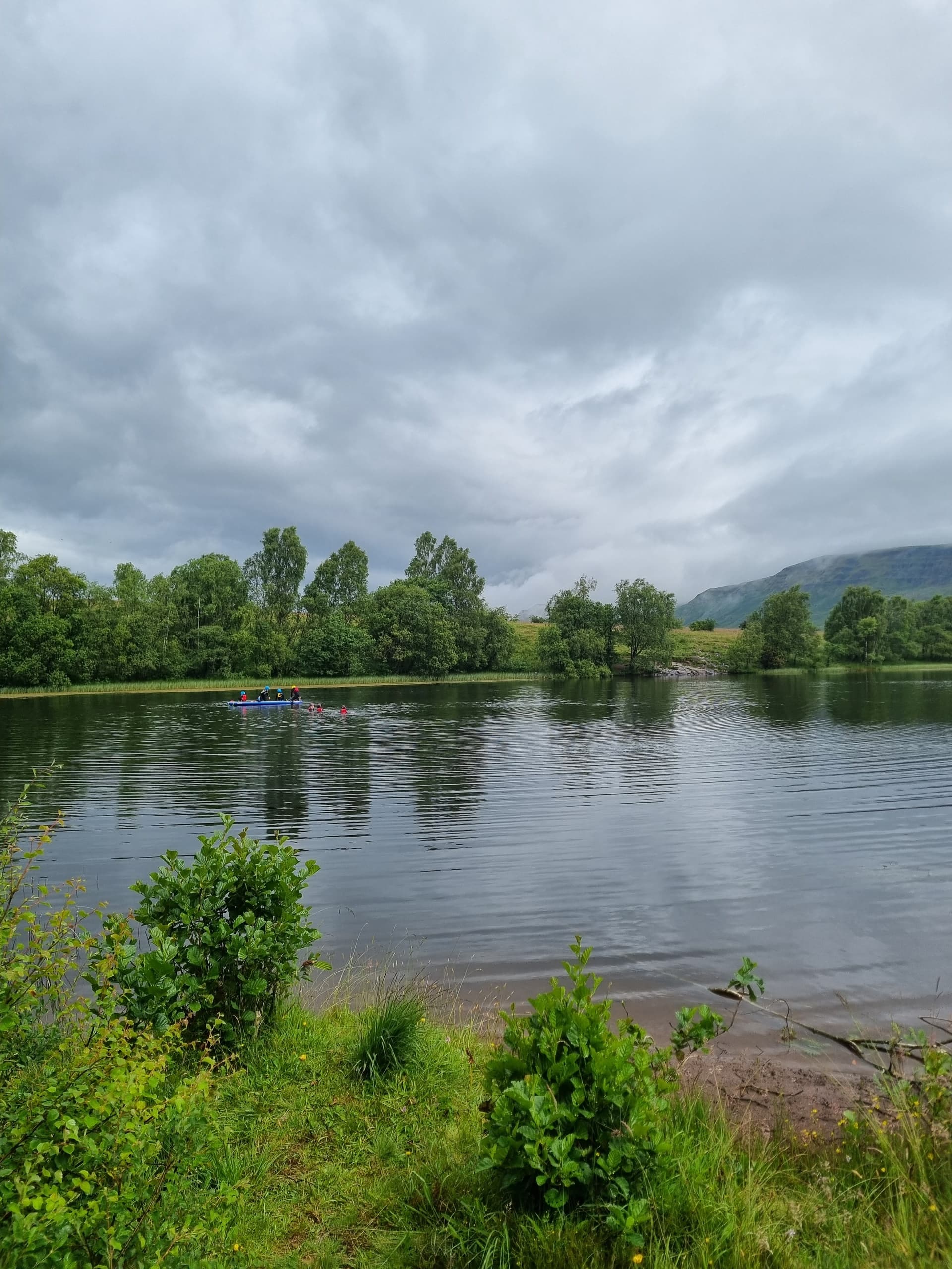 Calm river landscape with trees and reflective cloudy sky