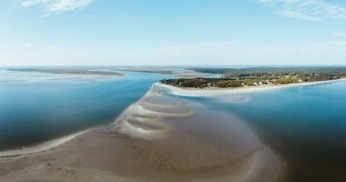 Aerial sandbars and coastal lagoon view, serene coastal flight