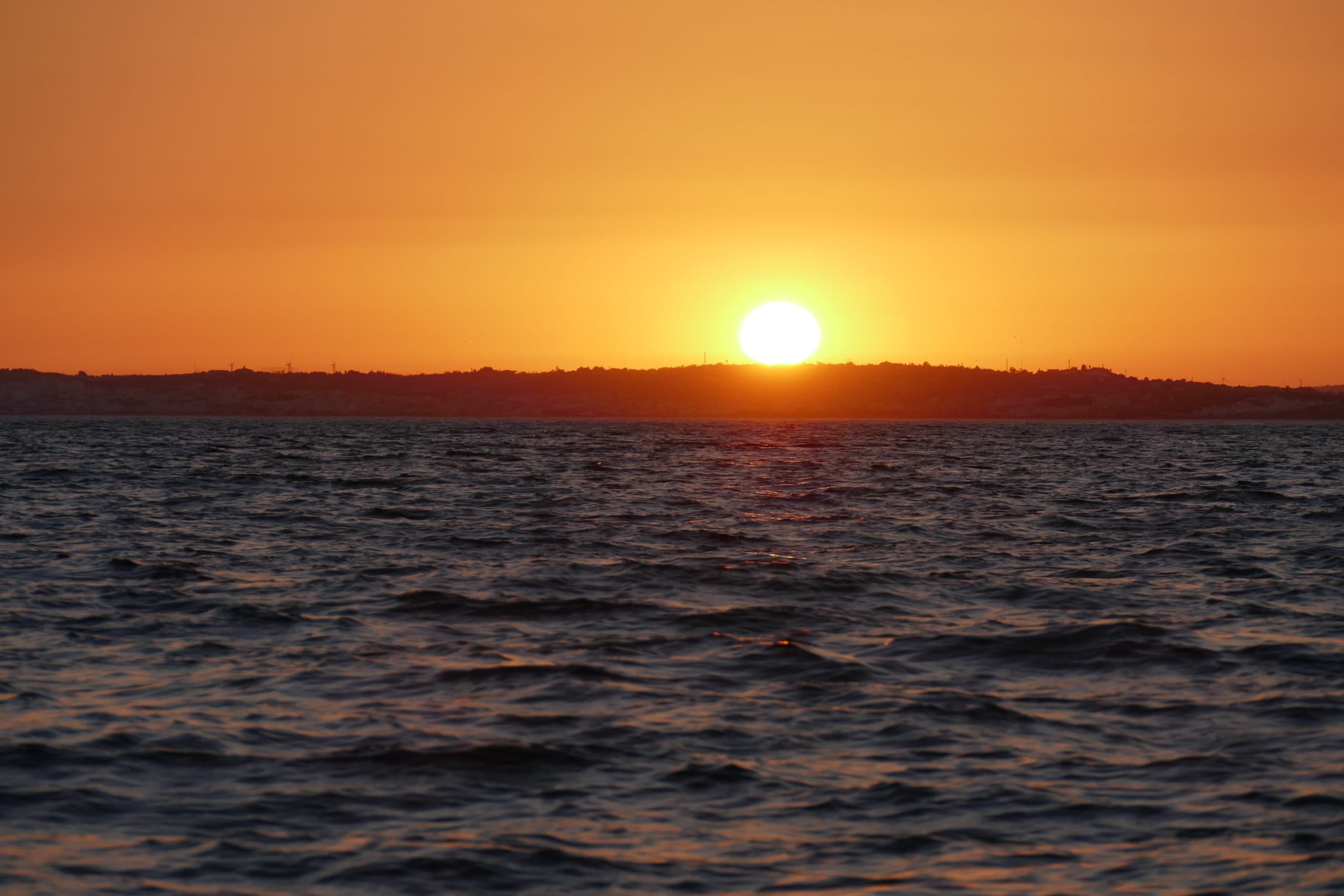Vivid ocean sunset horizon seen from evening sightseeing boat