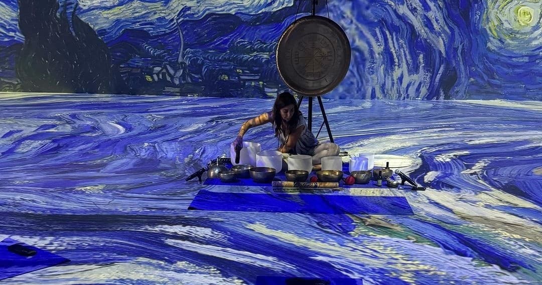 Artist performing sound mixing in immersive Van Gogh gallery