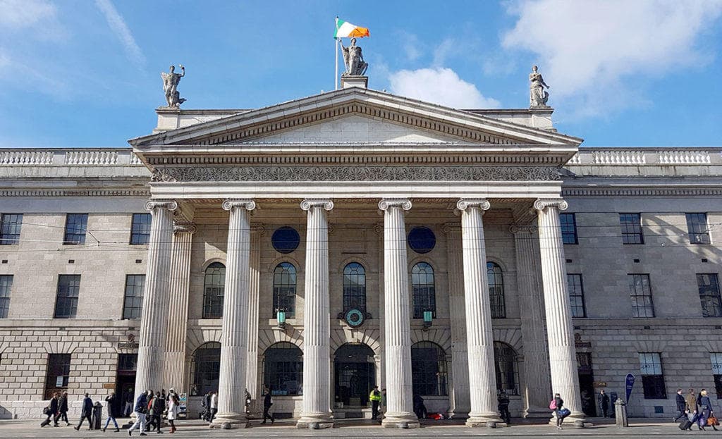 Grand neoclassical public building facade on urban street in Dublin