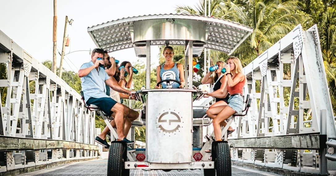 Party bike crossing scenic urban bridge in Fort Lauderdale