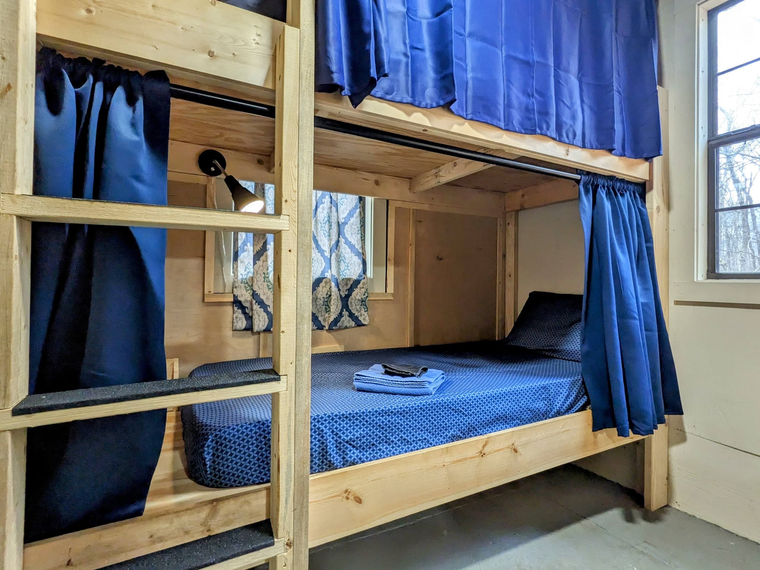 Wooden bunk beds in cabin dorm room for adventure groups