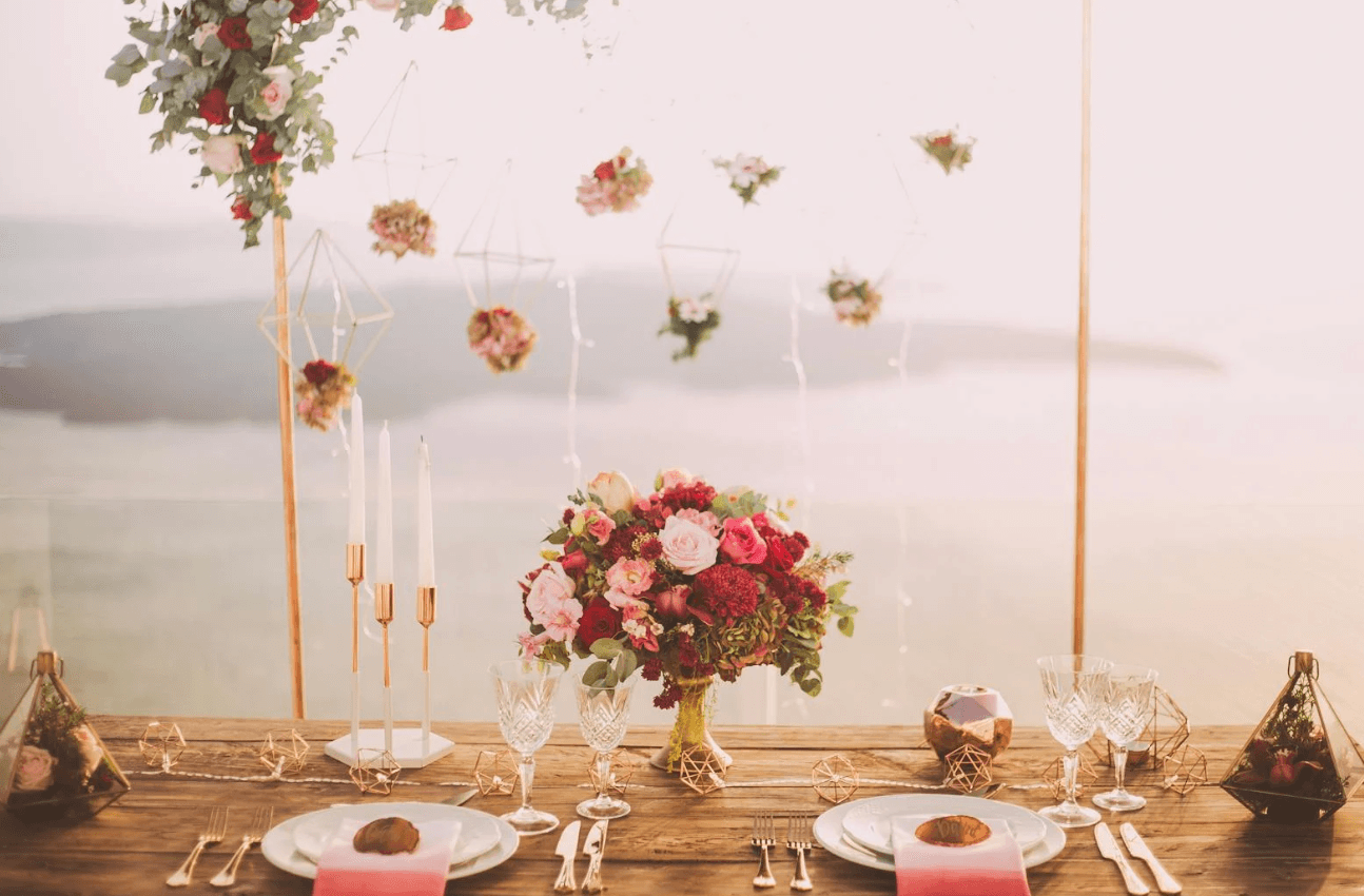 Seaside wedding table setup with floral decor overlooking ocean