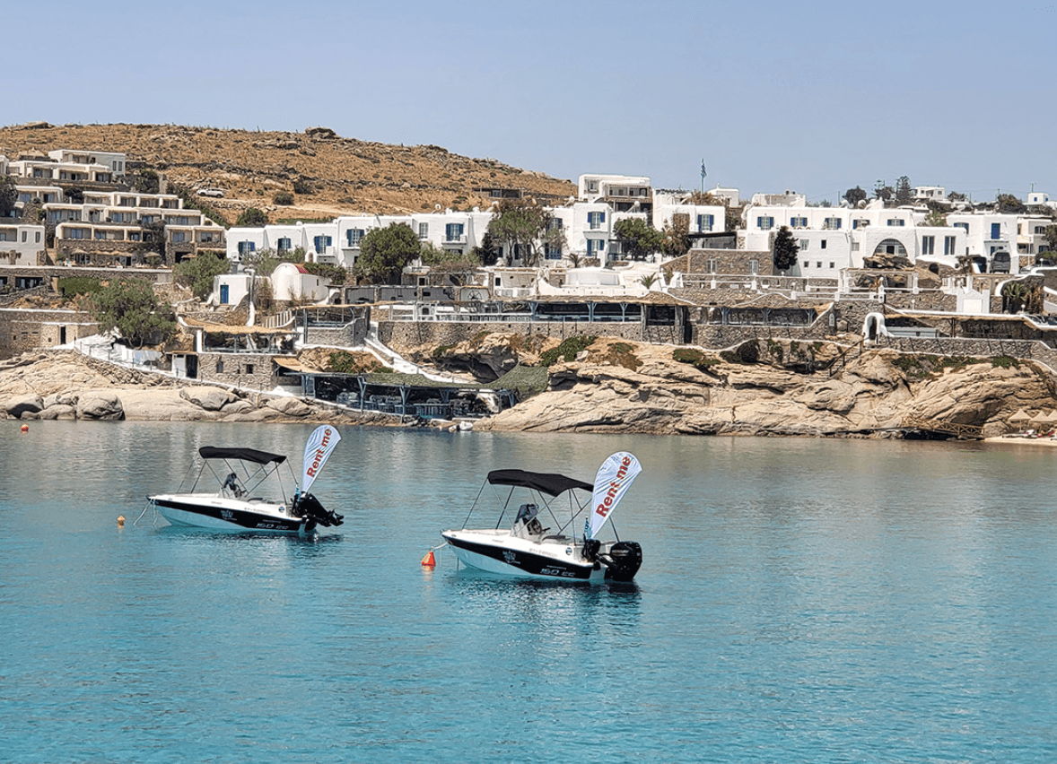 Two motorboats anchored in turquoise bay by Mediterranean coast