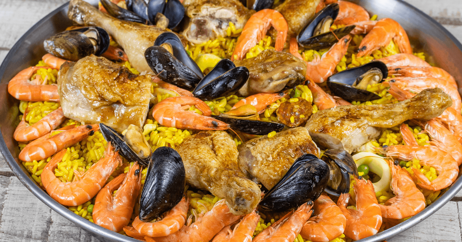 Seafood paella in large pan showcasing vibrant outdoor style feast
