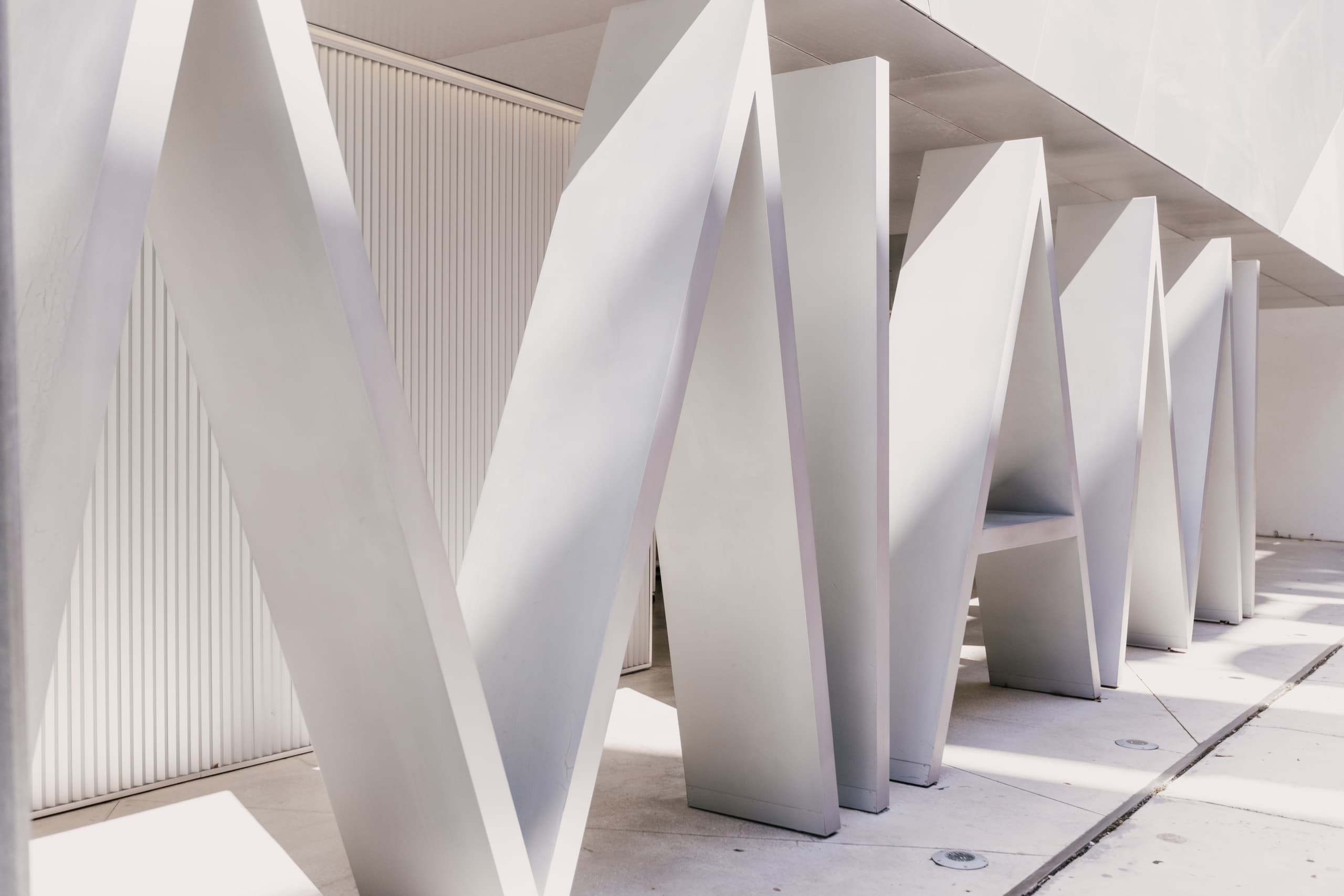 Minimal white architectural facade sculpture in Miami